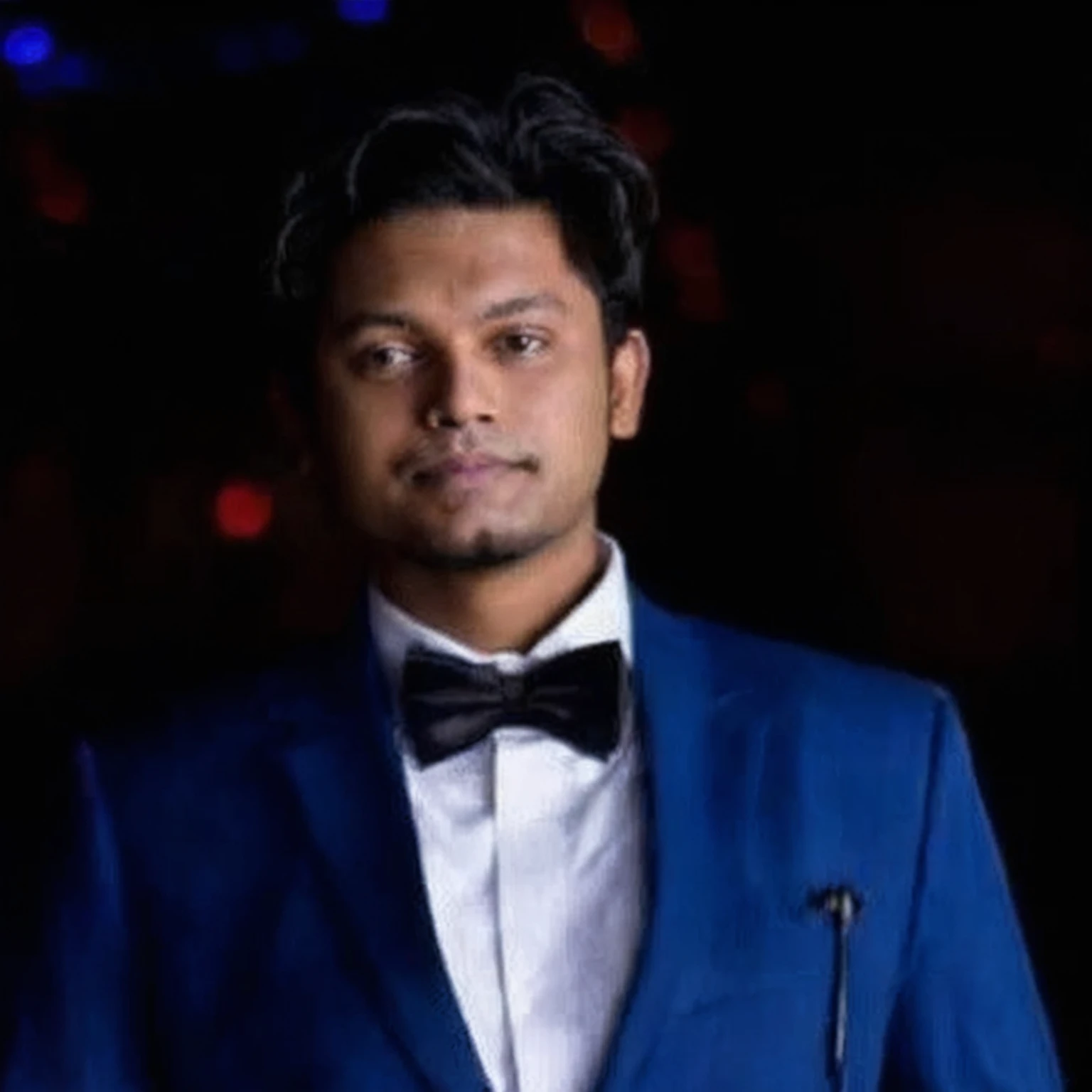 arafed man in a blue suit and bow tie standing in front of a dark background, jayison devadas, mohamed chahin, professional profile picture, trending photo, riyahd cassiem, photo taken in 2 0 2 0, ayan nag, avatar for website, in front of a black background, professional picture, profile photo, mohamed chahin style