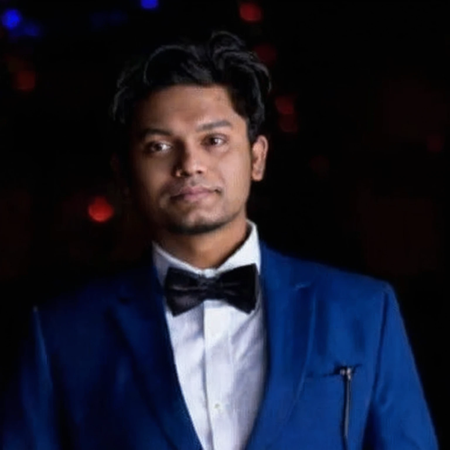 arafed man in a blue suit and bow tie standing in front of a dark background, jayison devadas, mohamed chahin, professional profile picture, trending photo, riyahd cassiem, photo taken in 2 0 2 0, ayan nag, avatar for website, in front of a black background, professional picture, profile photo, mohamed chahin style