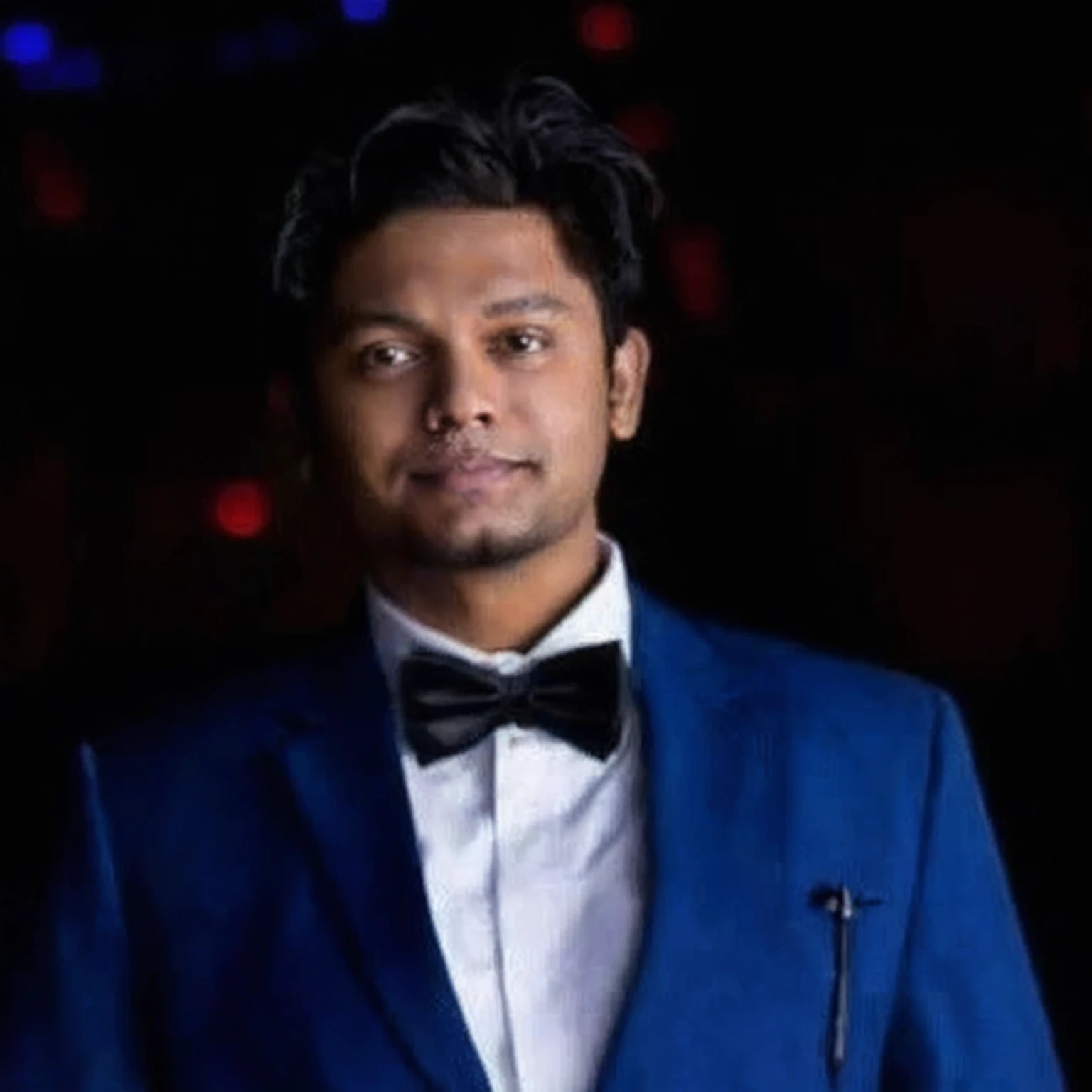 arafed man in a blue suit and bow tie standing in front of a dark background, jayison devadas, mohamed chahin, professional profile picture, trending photo, riyahd cassiem, photo taken in 2 0 2 0, ayan nag, avatar for website, in front of a black background, professional picture, profile photo, mohamed chahin style