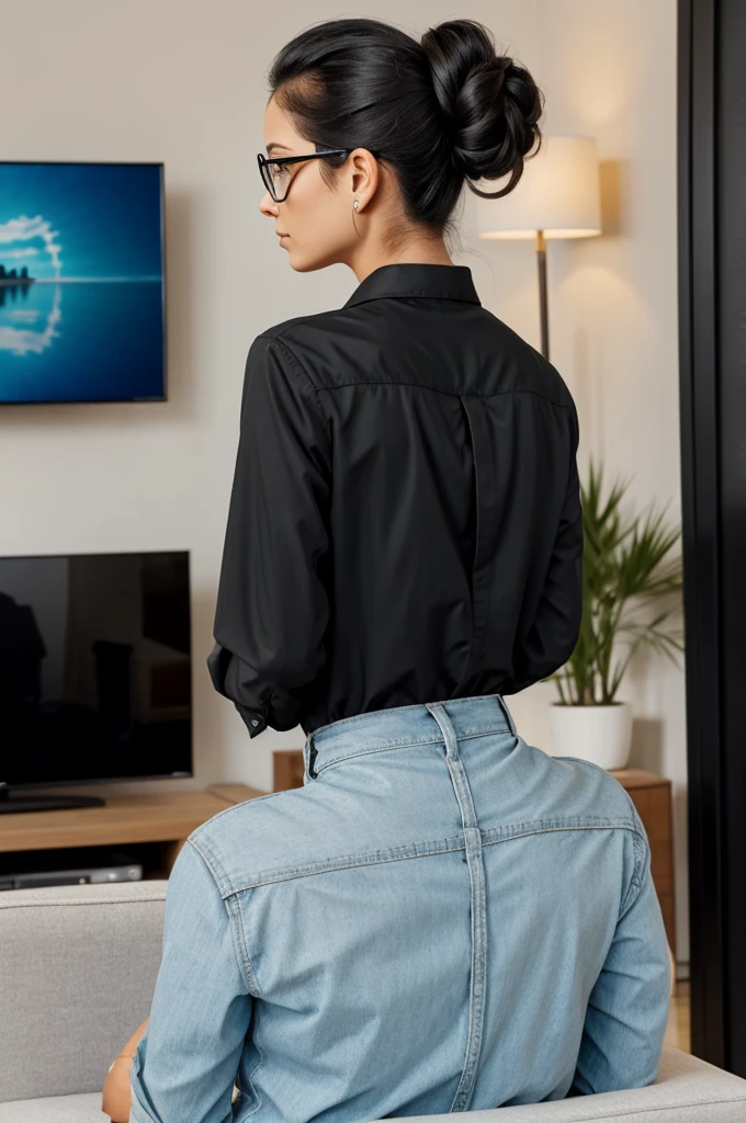 Woman from back watching large television with hair up glasses black hair and shirt name Erika number 10