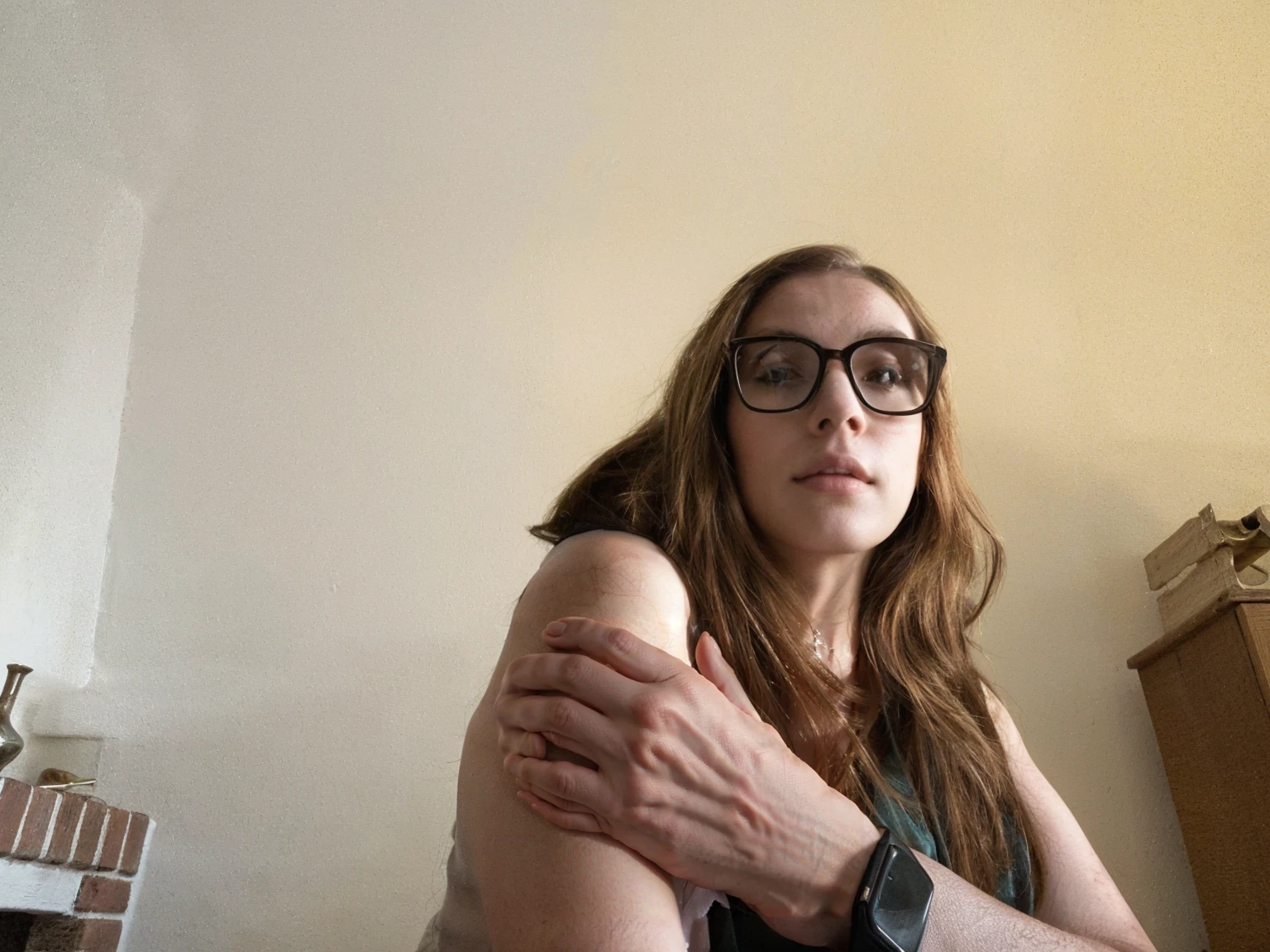 there is a woman with glasses sitting
