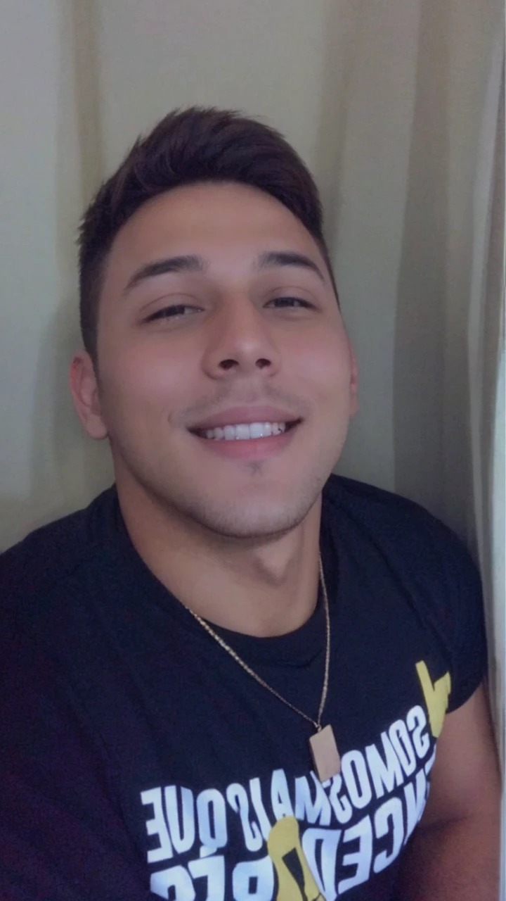 A young man, brown hair, calm smile