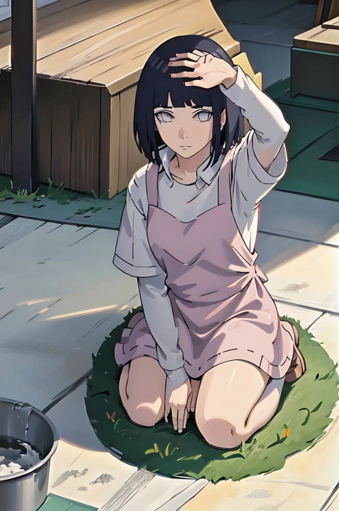Picking something from the ground,looking at viwer,wearing apron