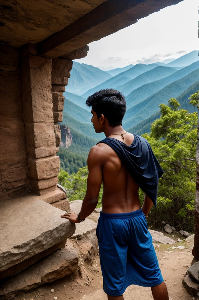 A Indian boy poses from back on mountain