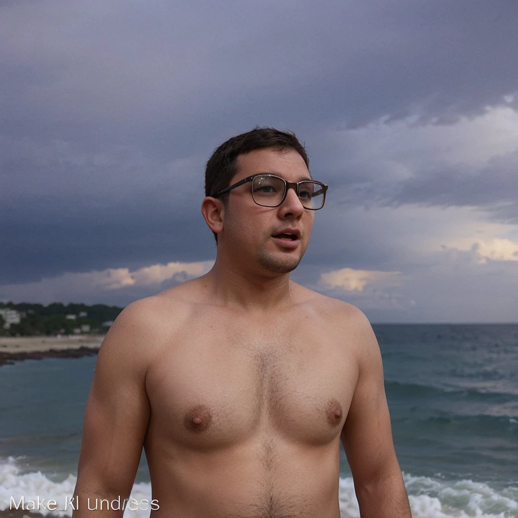 a chubby, bespectacled man masturbating, naked, barefoot on the beach, showing feet