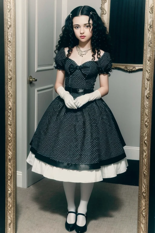 looking like Bellatrix Lestrange in black dress with white polka dots, with gloves, necklace with a blue stone, white socks and heels with small heels standing in front of the old mirror