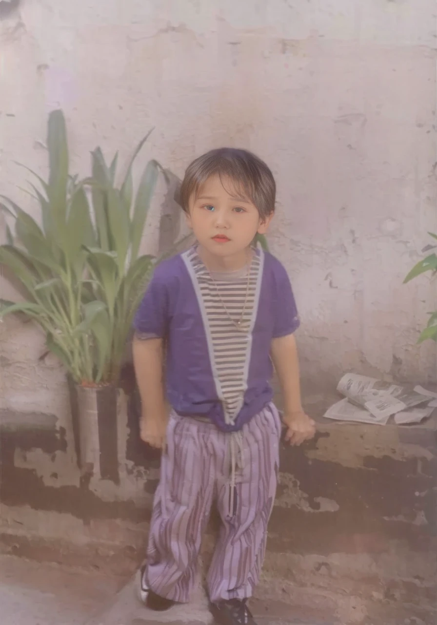 A boy wears a purple shirt with a striped pattern, striped pants, and black shoes, the  wears a necklace, in the background there is a large pot with green plants and there is also a newspaper, a white wall.