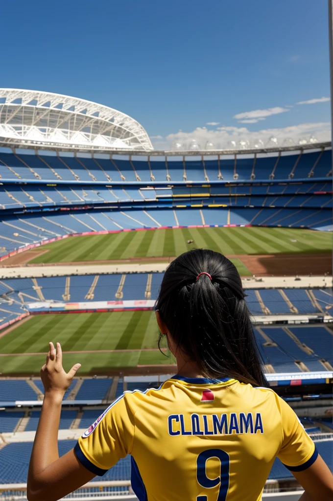 Woman from behind with a Colombia shirt with the name Leidy and the stadium in the background with her hands up, long black hair