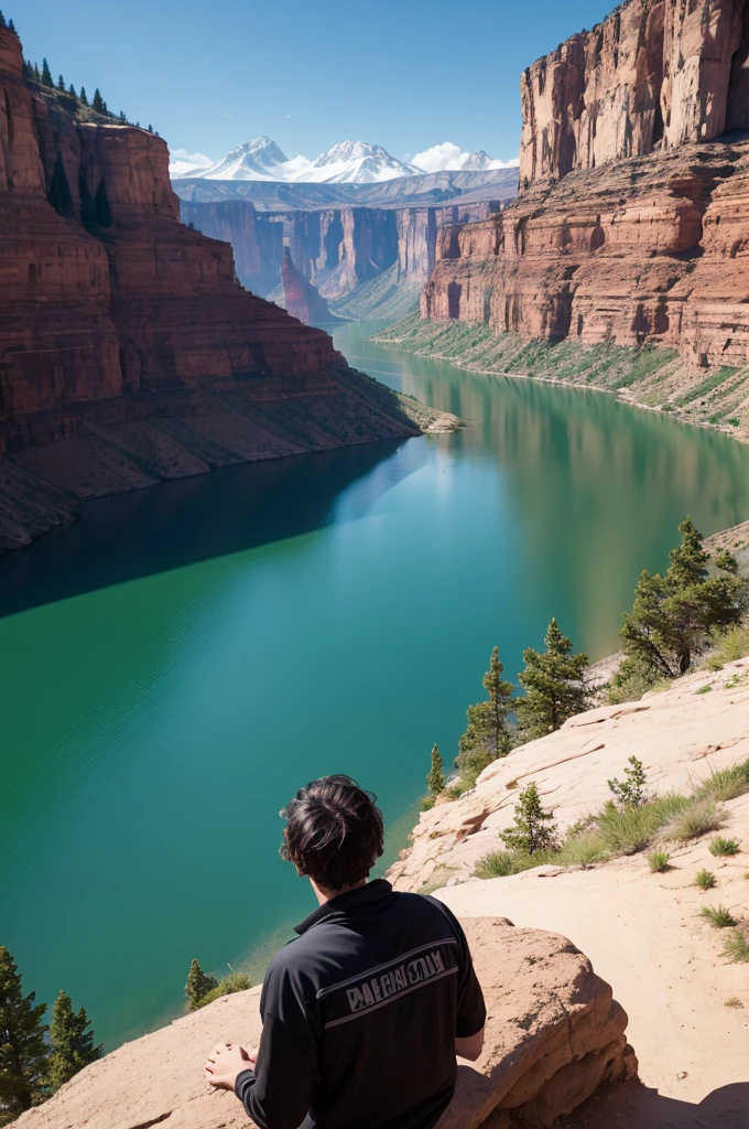A man looking at a lake in the middle of canyons