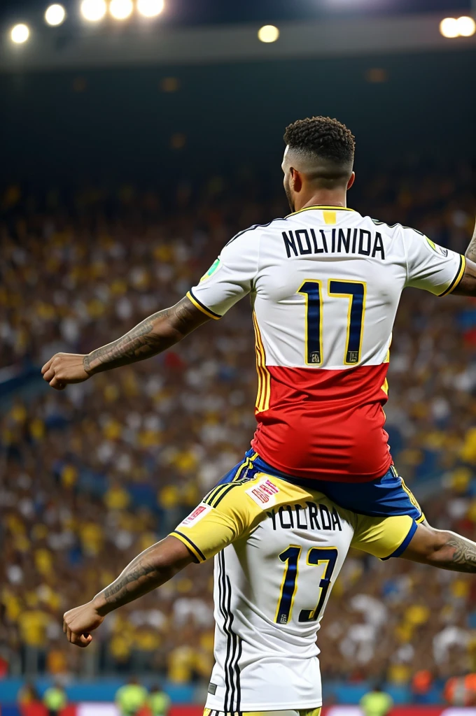 photo taken since his back of a man with the colombian shirt with the number 13 with the name NORMAN on the shirt, in the grades of the stadium celebrating with his arms extended