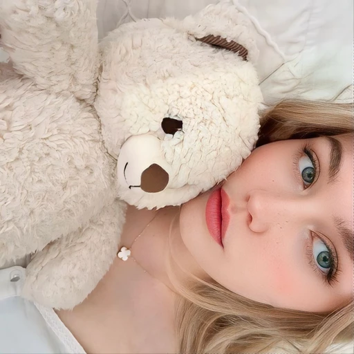 The white teddy bear, replace with a white stuffed cat