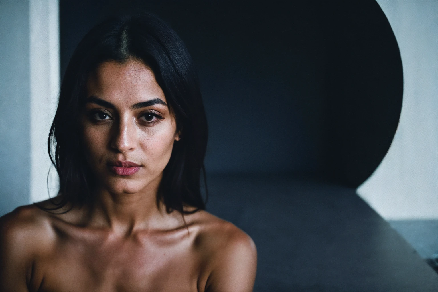 RAW photo,dark,moody,hazy atmosphere,35mm focal lenght,underexposed,cold,candid photograph,artistic,full body,photo of a beautiful,influencer,30yo Iranian woman,detailed skin,naked, looking away from viewer, thick body structure,grey background,no background, candid pose,dim room,blue light, film grain, kodak color, instagram LUT