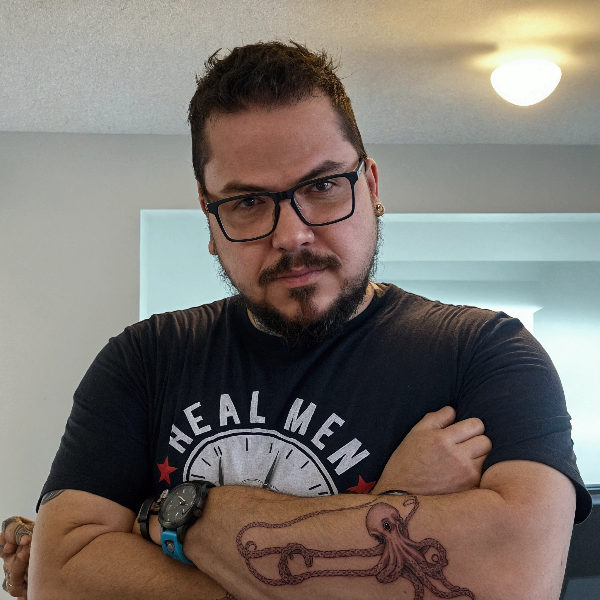 there is a man with a tattoo on his arm and a clock on his arm, with a squid tattoo on his arms, twitch streamer / gamer ludwig, neckbeard, extremely realistic, really realistic, arms crossed on chest, with nerdy glasses and goatee, with tattoos, typical cryptocurrency nerd, reddit post, profile image, stocky, very very realistic. On the fast car