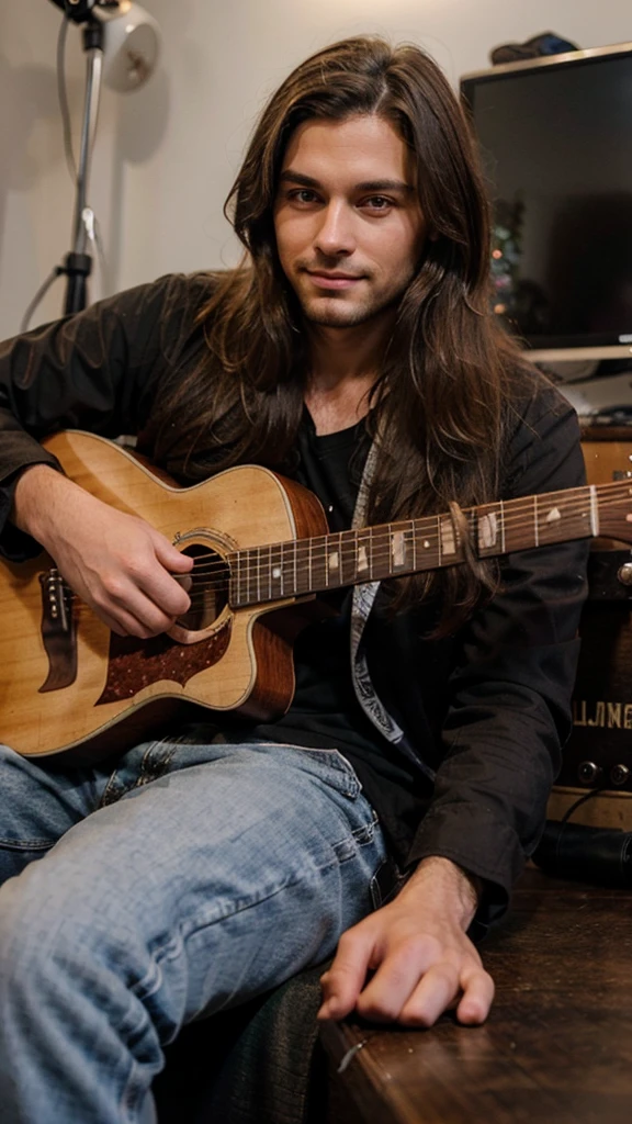 Handsome man with long brown hair sitting near the guitar, smirk