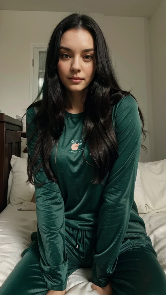 British lady with long black hair sitting on bed wearing bue green pajamas, selfie 