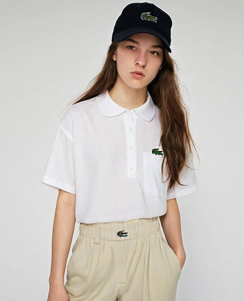 A 19-year-old woman with long hair and a backwards Lacoste black cap,a loose blouse and loose pants and a little line on the eyebrow,of lesbian sexuality and with pincergin in the corner of the mouth , appear full body showing baggy pants and baggy blouse