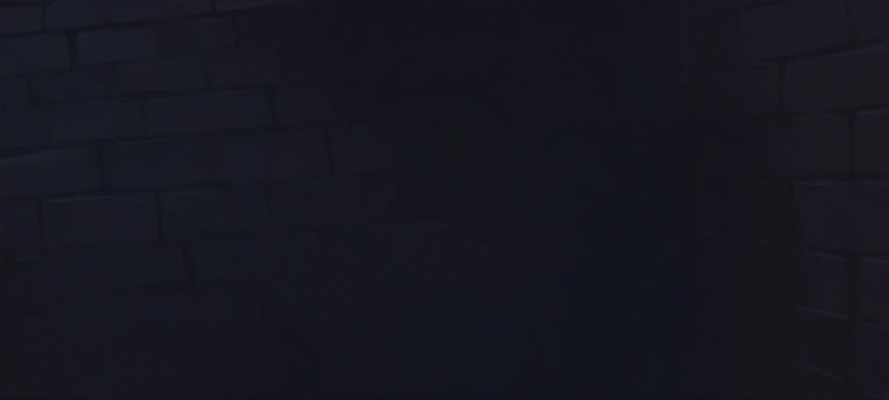 There is a greyish and blueish bricked wall
