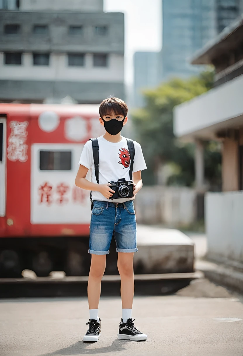 age boy with red demon mask with gold touches holding a camera dressed in a white sleeveless shirt and denim shorts