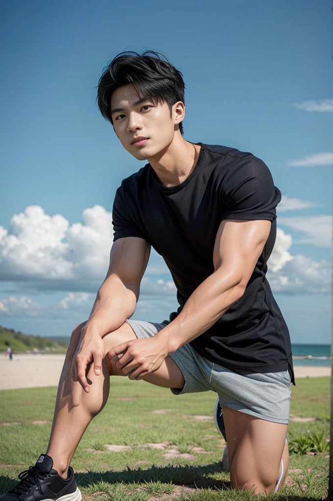 A young Asian man stands, handsome, muscular, looking at the camera. In a simple black t-shirt, Fieldside, grass, beach, sunlight