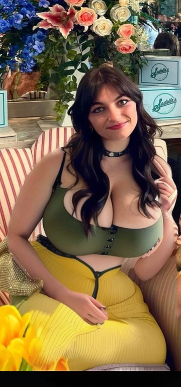 there is a woman sitting on a couch with flowers in the background, pretty female phoebe tonkin, lucy hale, phoebe tonkin, by Emma Andijewska, christina kritkou, kaitlyn michelle siragusa, joey king, green dress, profile photo, very very low quality picture, justina blakeney, Big tits, huge , no clothes, sexy, cute, wide hips, thick thighs, pear-shaped body, minimal clothes, thick, bbw, chubby stomach, thick nipples, nipple piercings, large areola, hard nipples, piercing through shirt, nipples hard through shirt, busty, major cleavage, naked, ripping through top, spilling over sides, bra too tight, giant , dominatrix, dominatrix clothes, revealing clothes, ass so fat you can see it from the front, giant tits, huge ass, wide girl, naked