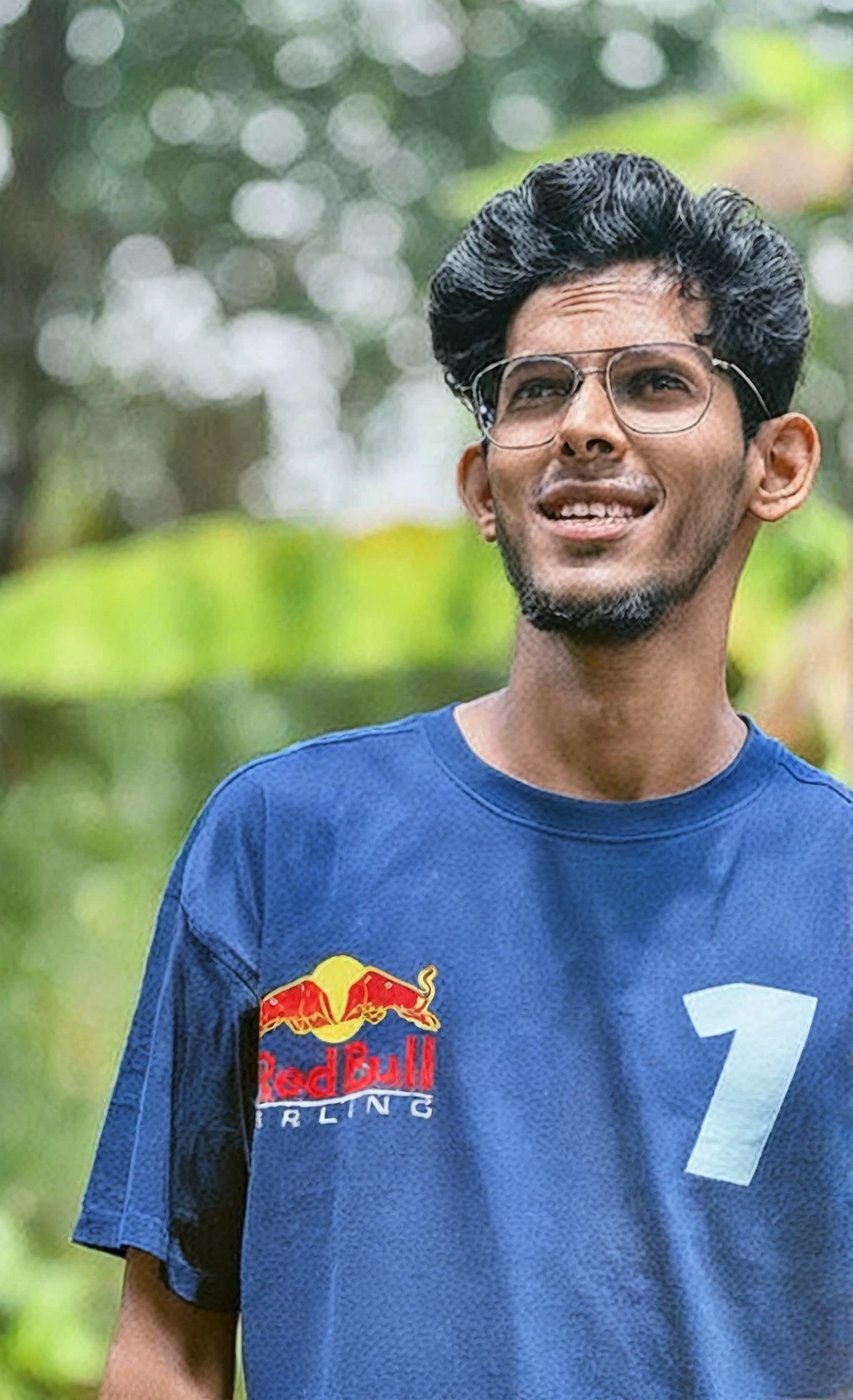 arafed man with glasses and a blue shirt is holding a banana, mohamed chahin, jayison devadas, mohamed chahin style, jayison devadas style, red bull, inspired by Nathan Oliveira, ismail, mutahar laughing, riyahd cassiem, mid shot portrait, post, front profile!!!!, ayan nag
