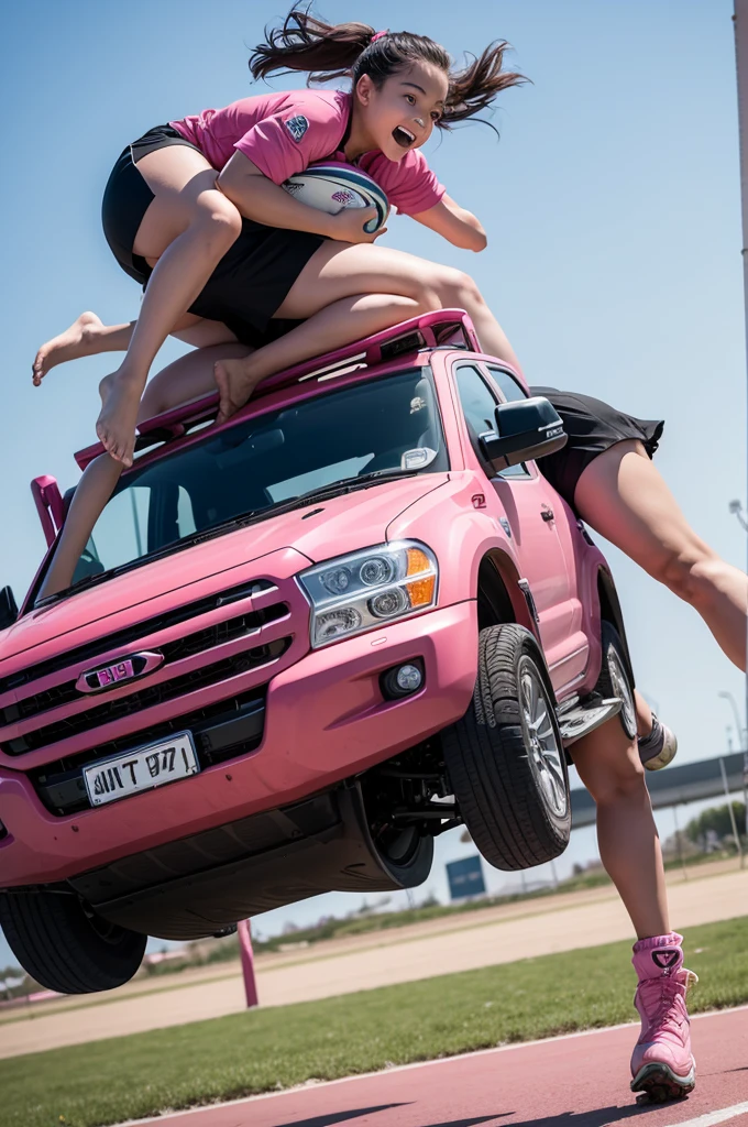 image of girls playing rugby on top of a pink truck