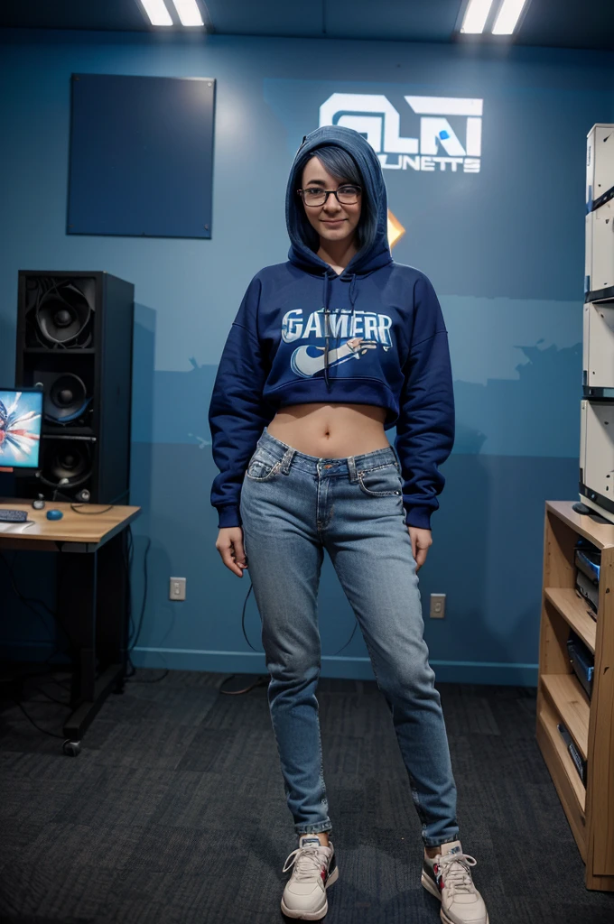 A full-body image of a slim woman with glasses, dyed blue hair, and an excited expression. She is dressed in a casual gamer outfit with a hoodie, jeans, and sneakers. She stands in a room filled with other gamers, computers, and cables, holding a game controller. The background shows a lively LAN party atmosphere