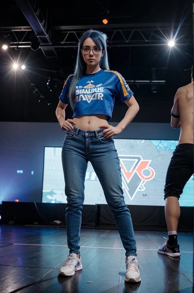 A full-body image of a slim woman with glasses, dyed blue hair, and a competitive spirit. She is wearing a team jersey, jeans, and sneakers. She stands on a stage with a game controller in hand, ready to compete, with an excited crowd and e-sports branding in the background