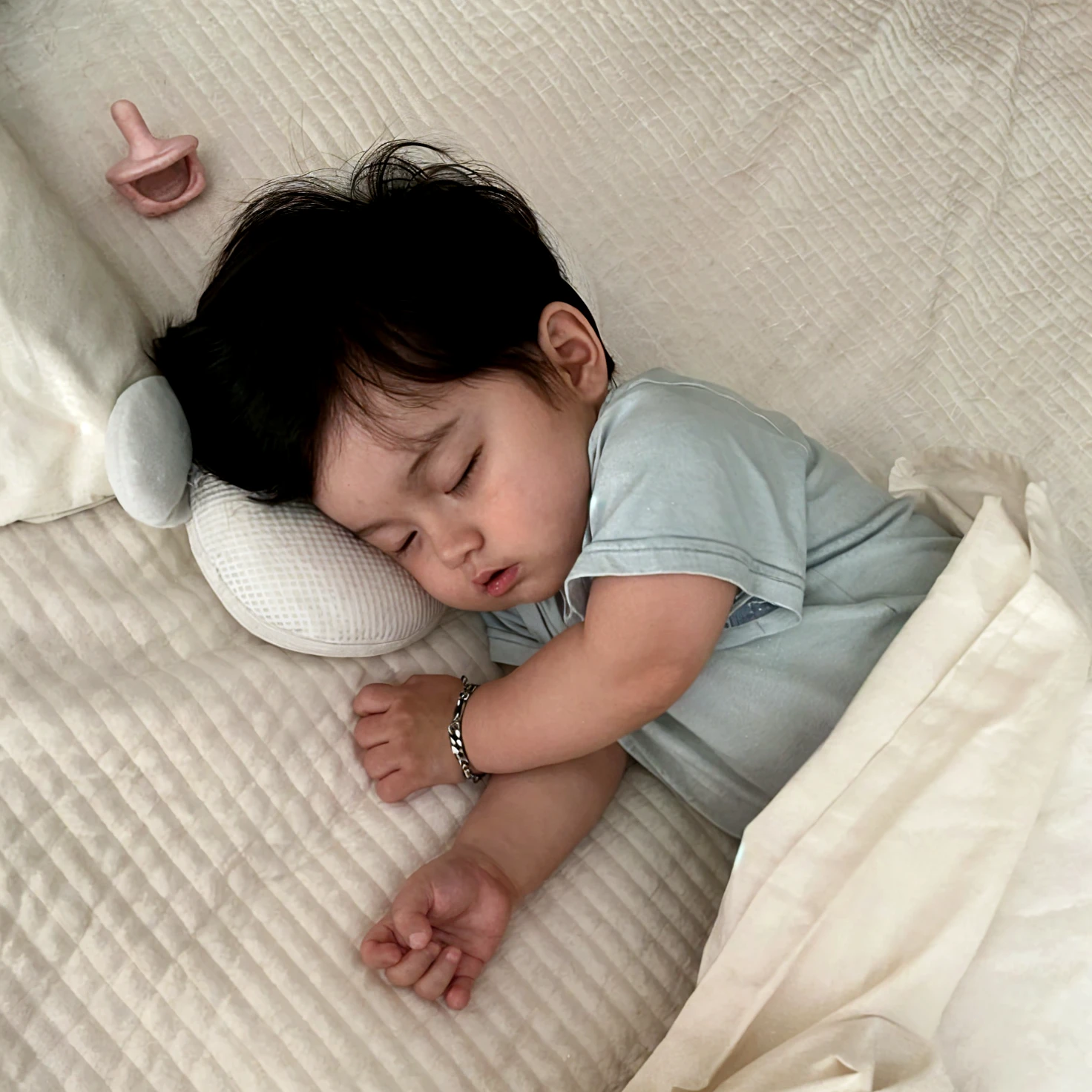 There was a baby sitting on the bed,There were blankets, 2 years old, Manhwa Style,s Ultraman