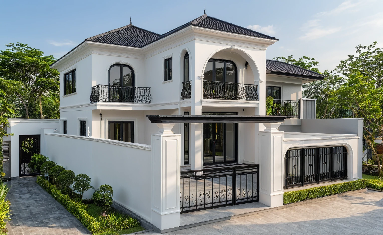 (masterpiece:1.2), best quality, photo of A two-story modern house in VietNam with white walls and dark tiles on the roof., tree and plant environment,black detail and (wooden ceiling:1.2), daylight, streetcapes, natural light, vivid color, The exterior of an elegant single family home features large windows, a dark gray door frame.