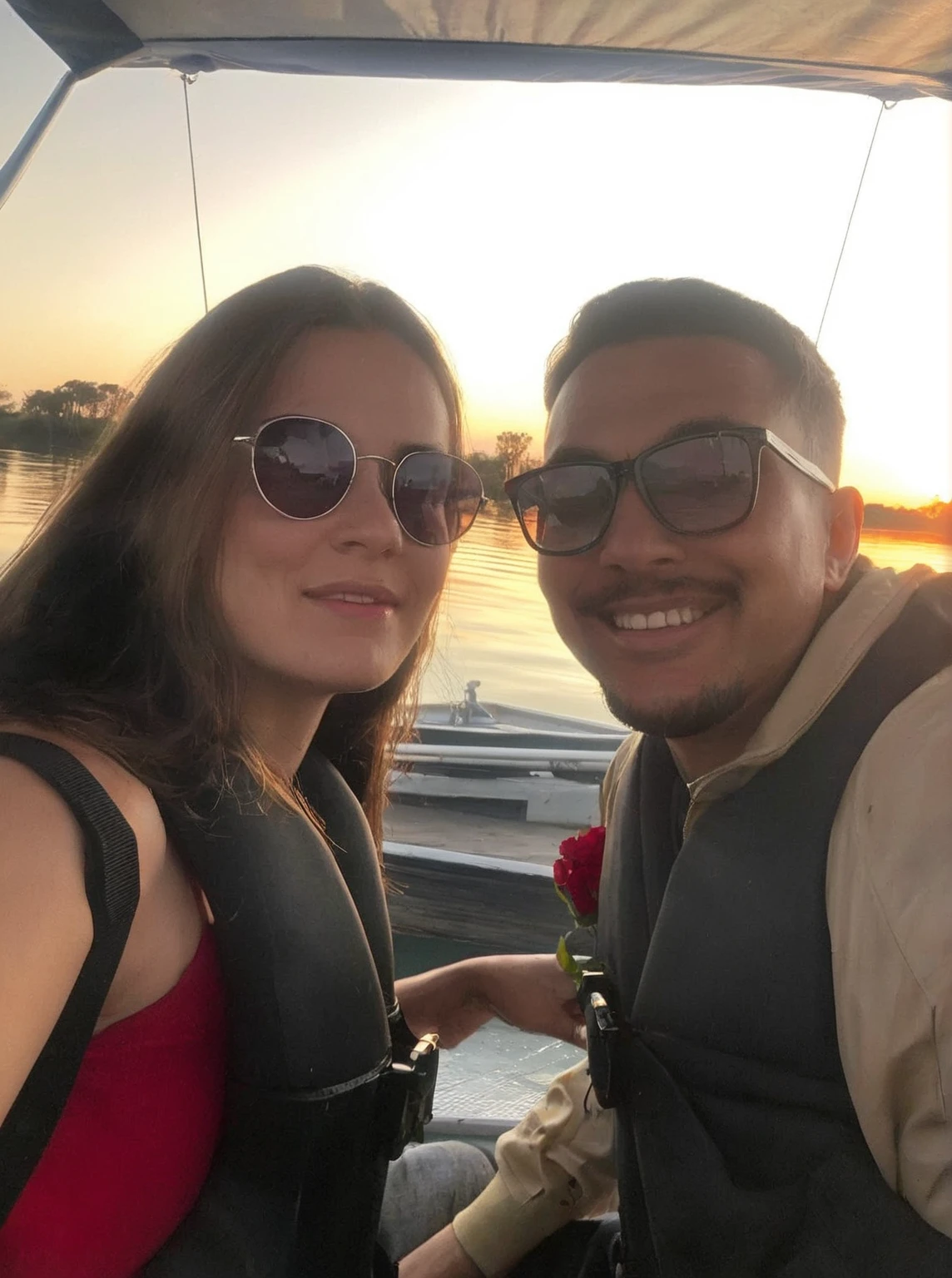 they are on a boat on the water At the sunset, on a boat, on a boat on a lake, at sunset, during sunset, with sunset, At the sunset, on a lake, casal feliz, At the sunset, Sunset view, taken at the beginning of 2020, having a lot of fun, sunset in the background, during a sunset, Lovely couple