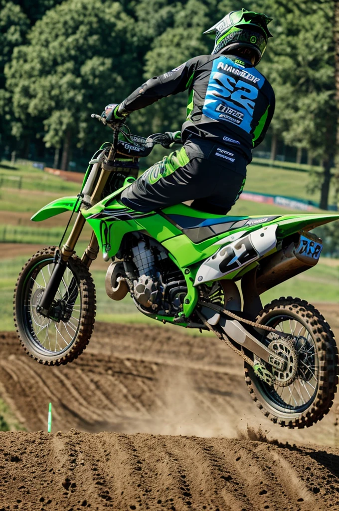 Image from behind of motocross rider with number 128 on top of a green Kawasaki motorcycle