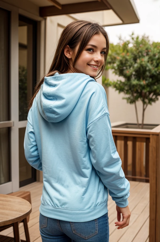 photo of a beautiful girl wearing only a casual tiny light blue shirt with a hoodie and, brown hair with light highlights, in a patio, half naked, fit body, view from back, medium upper body shot, looking at the camera, cute smile, shallow depth of field