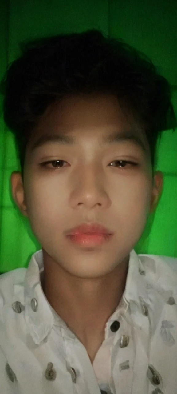 Realistic photos of (1 Cute Korean Male Celebrities) at eye level, sitting in front of a window with a coat on, a cigarette dangling from his fingers, and dim lights surrounding the scene. The clear facial features are showcased in crisp, lifelike details, making it an 8K high resolution masterpiece. Taken with an F/4.0 aperture and 135 mm lens on a FujiFilm camera, the jpeg artifacts and slight jitter add to the raw, authentic feel of the image. Ultra HD quality adds to the overall beauty and realism of this photorealistic portrait.