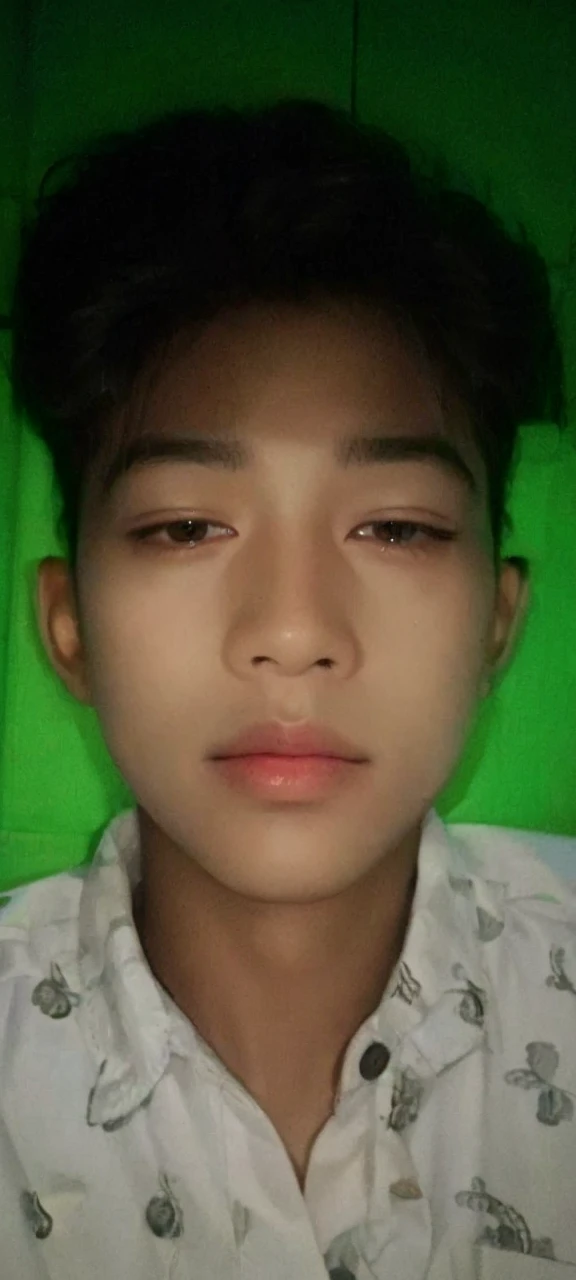 Realistic photos of (1 Cute Korean Male Celebrities) at eye level, sitting in front of a window with a coat on, a cigarette dangling from his fingers, and dim lights surrounding the scene. The clear facial features are showcased in crisp, lifelike details, making it an 8K high resolution masterpiece. Taken with an F/4.0 aperture and 135 mm lens on a FujiFilm camera, the jpeg artifacts and slight jitter add to the raw, authentic feel of the image. Ultra HD quality adds to the overall beauty and realism of this photorealistic portrait.