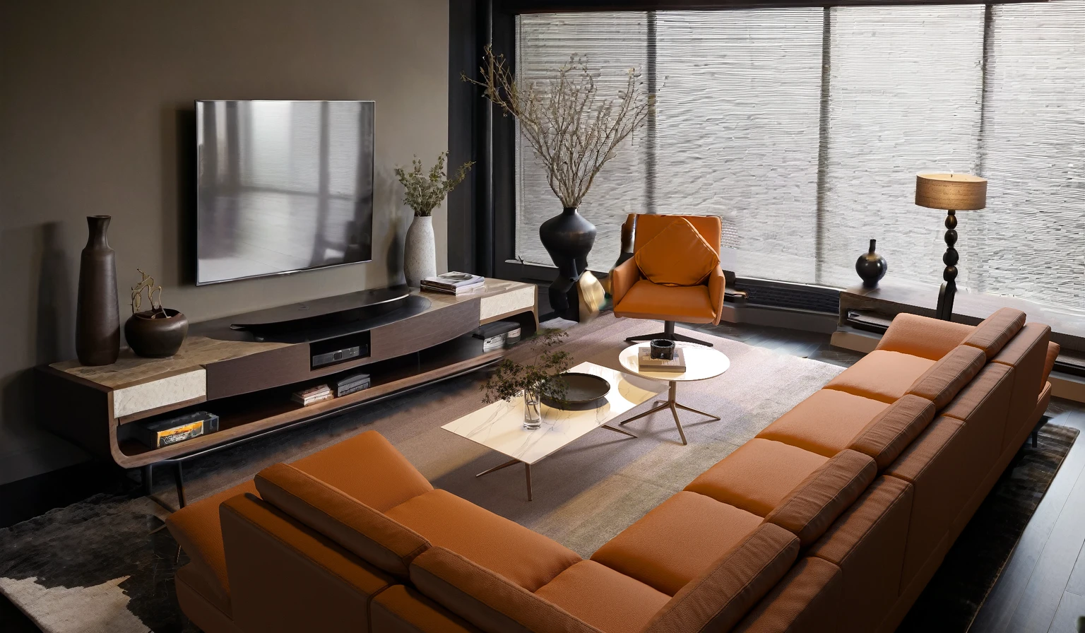 Chapter: The image depicts a modern living room with a focus on comfort and entertainment. The room features a large sectional sofa upholstered in brown leather, positioned in an L-shape in the center of the space. In front of the sofa, a black coffee table with a unique shape rests on a textured rug. Two matching brown leather armchairs with rounded backs and metal frames are placed to the right of the coffee table.