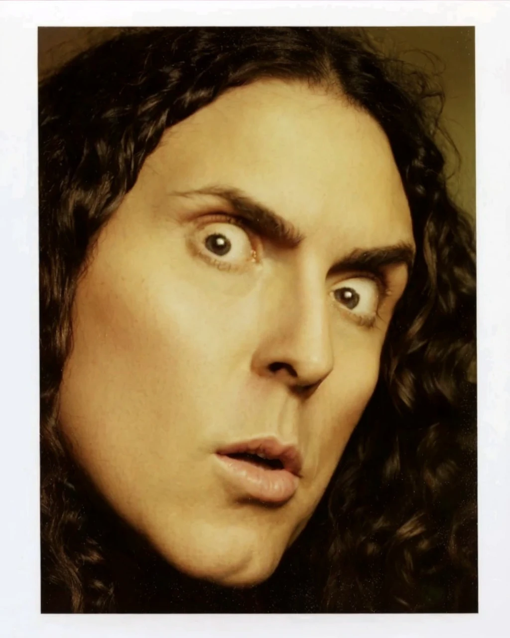 Weird al yankovic hugging a girl with short purple hair