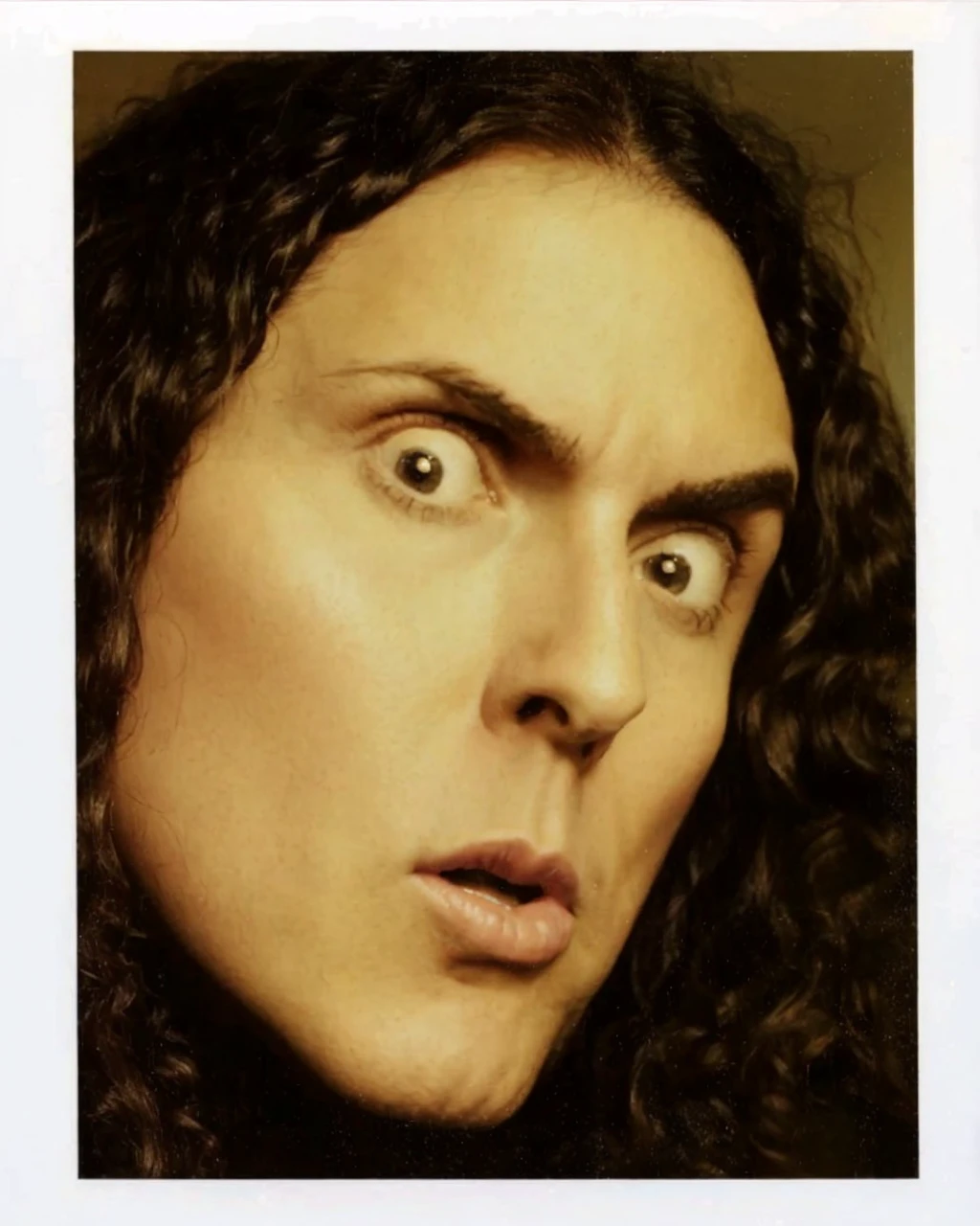 Weird al yankovic hugging a girl with short purple hair