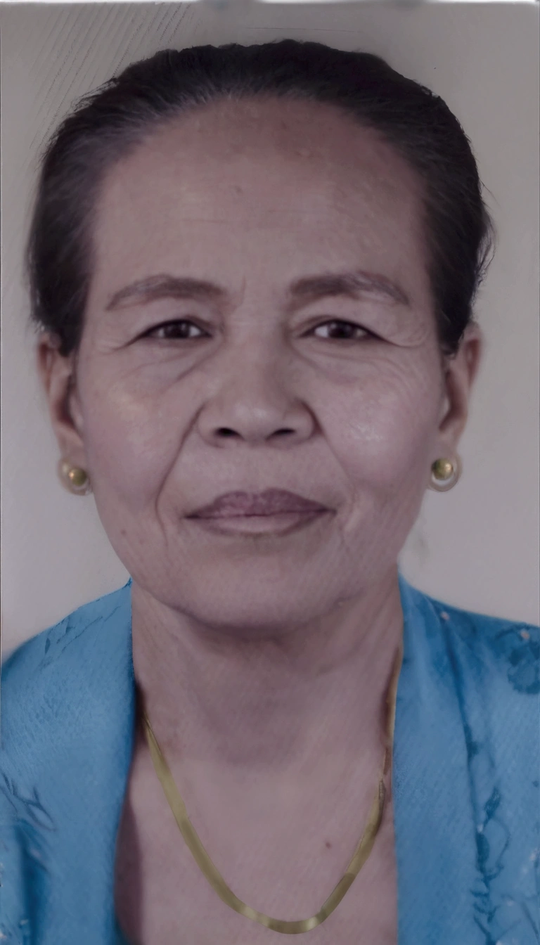 there is a woman with a necklace on her neck and a blue shirt, photo of a woman, taken in the early 2020s, portrait 6 0 - year - old woman, 60 year old woman wearing traditional Balinese kebaya, black earrings, gold necklace