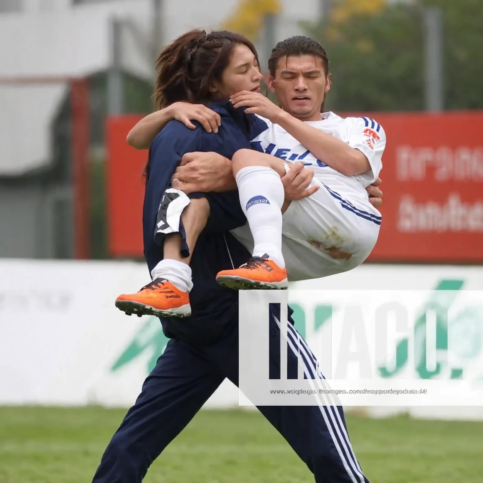soccer action pose, affection pose, sports injury scene, injured male soccer player, longhaired chinese female medic, a hurt male soccer player is being carried in the arms of a chinese woman with ponytail, lecherous action pose, dramatic action pose, theatralic pose, there is an attractive chinese woman with long hair and ponytail in a shiny red coat, a longhaired chinese woman that is carrying a wounded sportsman, there is a beautiful woman in a shiny coat who is carrying an injured young man in her arms, a longhaired beautiful woman in a high-shine red puffy coat, a longhaired woman in a shiny downcoat, a woman is carrying a shorthaired man who is wearing shorts and a t-shirt, a weak man in spots shorts is consciousless and needs to be carried, a hurt soccer player in a matte cotton sports outfit is rearing up in pain in the arms of a chinese woman who is carrying him in her arms, a shorthaired man with closed eyes is carried in the arms of a longhaired woman, a woman looks very scared and terrified, a consciousless man with closed eyes is suffering very much and has a very painful face, photo, photo shoot, photographed , accident, help, aid, first aid, pity