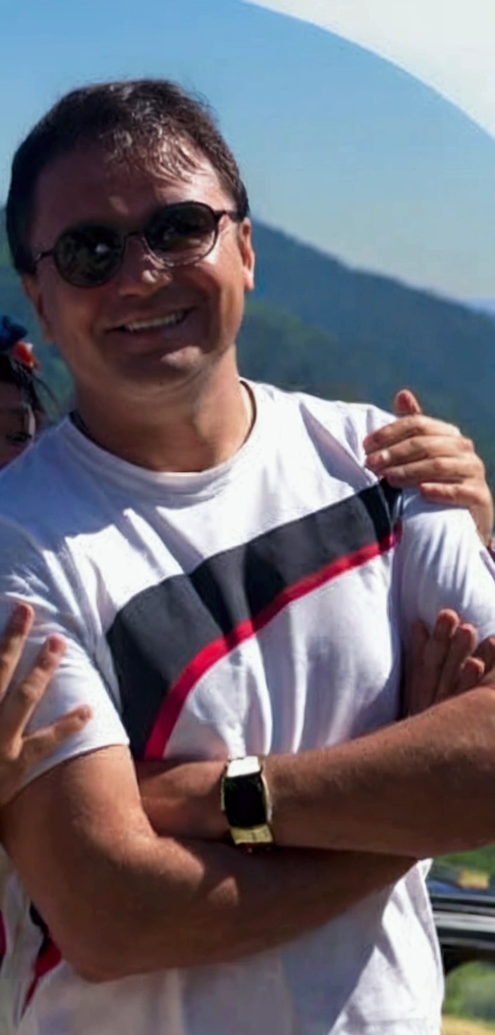 
man smiling with forest in the background