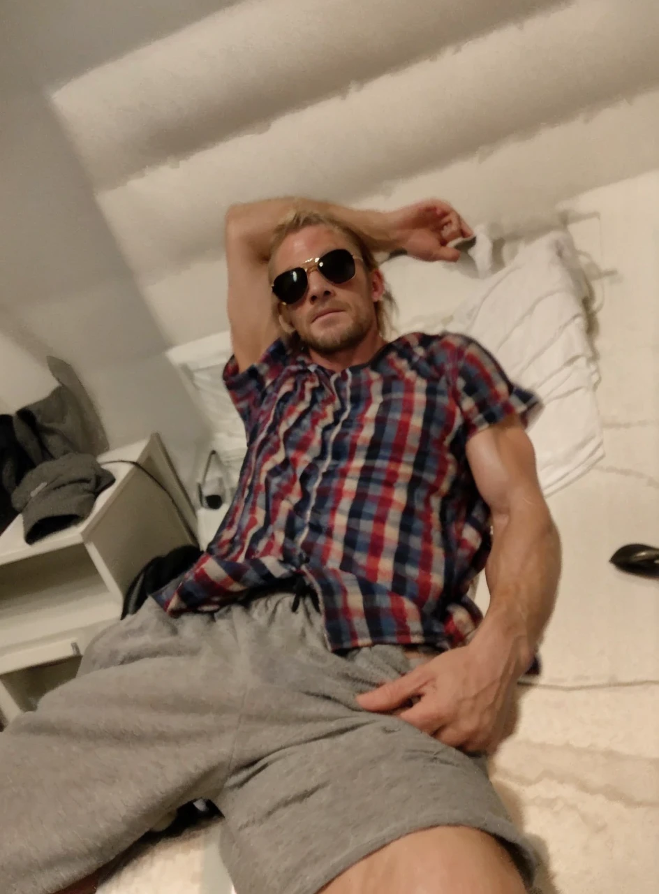 (RAW photo:1.4), Chris Hemsworth looking at viewer, smirk, full body, wearing tank top, sweating, towel around neck, standing, dark features, smooth, muscles, barefoot, ((steamy locker room setting)), intricate details, 8k, ultra-high-definition, (photo-realistic:1.3),(fit and sculpted physique:1.1), (accentuating his every curve:1.1), (subtle sheen and texture:1.2), (soft and brightly lit:1.2), (muted color palette:1.1),