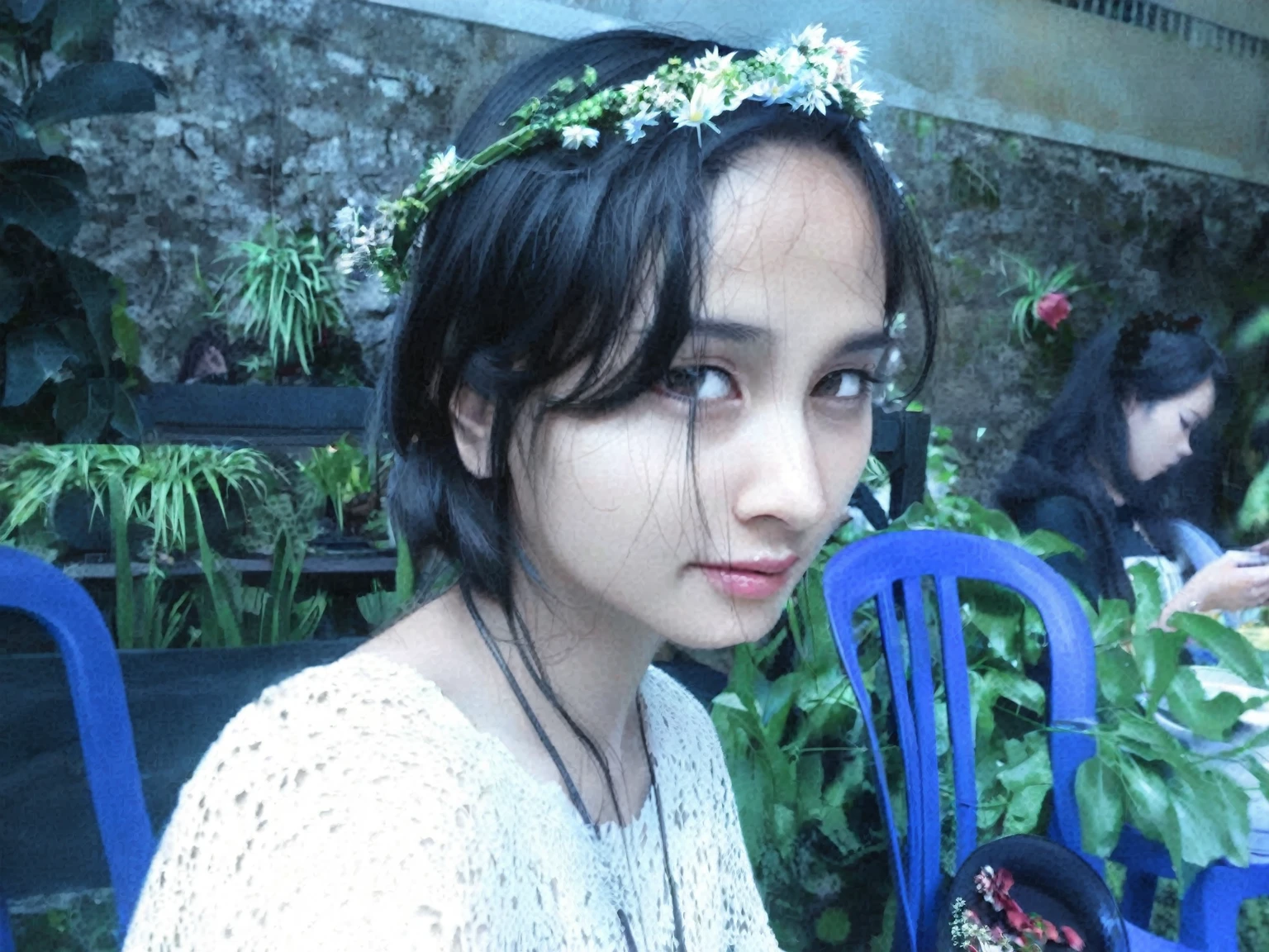 there is a woman sitting at a table with a plate of food, wearing a flower headpiece, wearing a floral crown, she has a crown of flowers, with flowers, she has a crown of dried flowers, wearing a crown of vines, wearing angel halo, flower crown, nivanh chanthara, lotus floral crown girl, with ivy, in garden