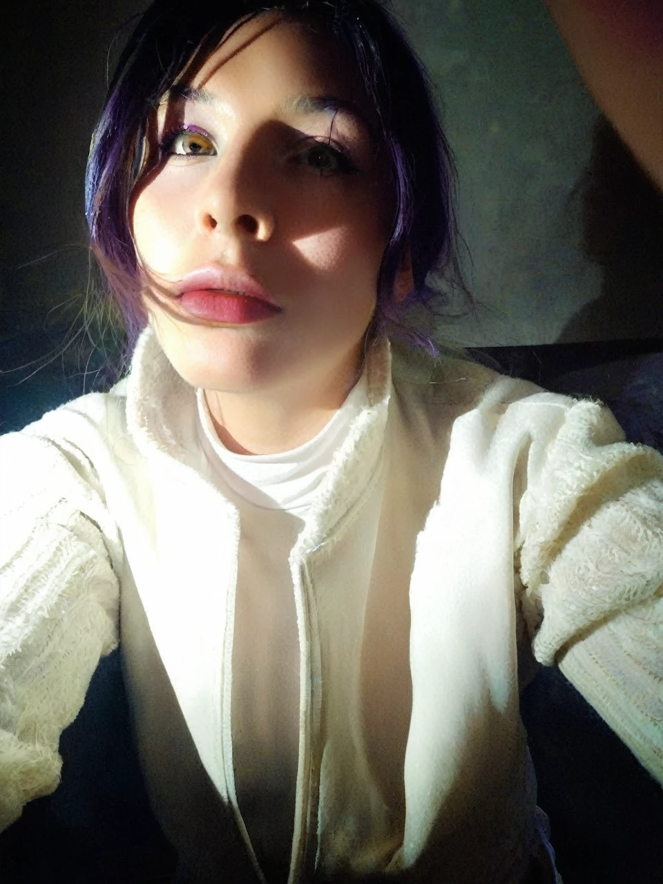 Frontal portrait of an extravagant and colorful woman who resembles a mermaid. Perfect body, natural , clear skin, young features, wide open eyes and delicate freckles on the nose and cheeks. Front view, Vibrant, gravity-defying hair in shades of purple, blue and orange. Her hair transforms into tendrils or aquatic flora, creating an underwater illusion. Small bubbles floating around the head add to the underwater theme. General Effect: Serene otherworldly underwater creature in silent contemplation.