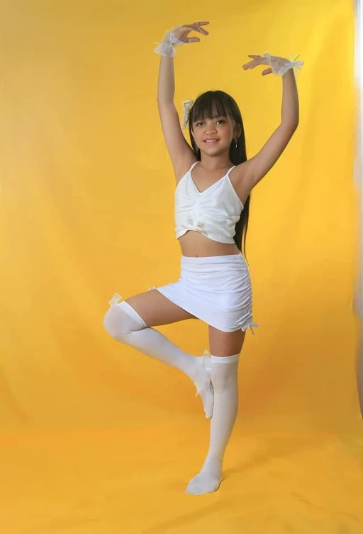 Tween girl in white dress and white socks posing for a picture, wearing white leotard, girl in white dress dancing, white skirt and barechest, wearing white tights, in white clothes, ballet style pose, leotard and leg warmers, wearing white skirt, posing in leotard and tiara, white tights, playful pose of a dancer
