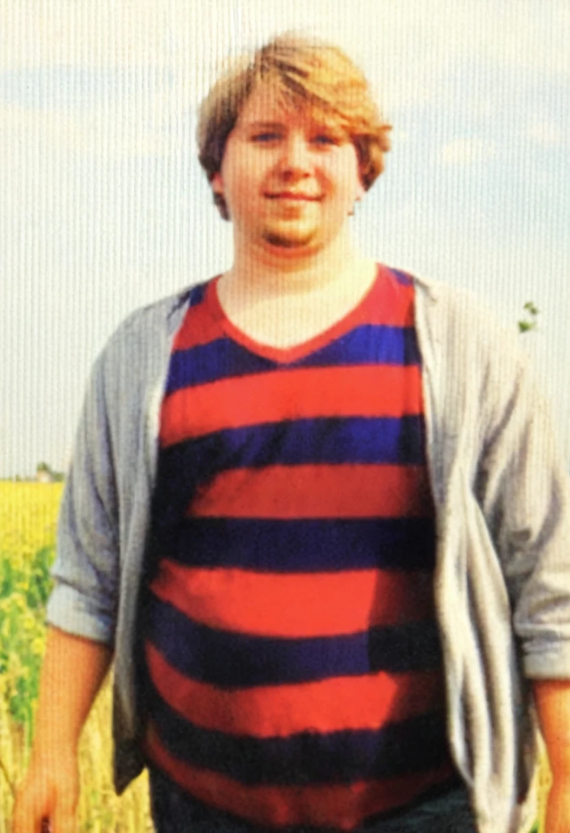 there is a man standing in a field, around 20 years old, he has a round belly, fat, chubby, overweight,
