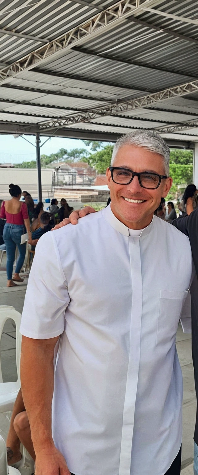 A tall man, strong body, smiling, black glasses, no beard, short gray hair, wearing a priest's outfit and on a white background