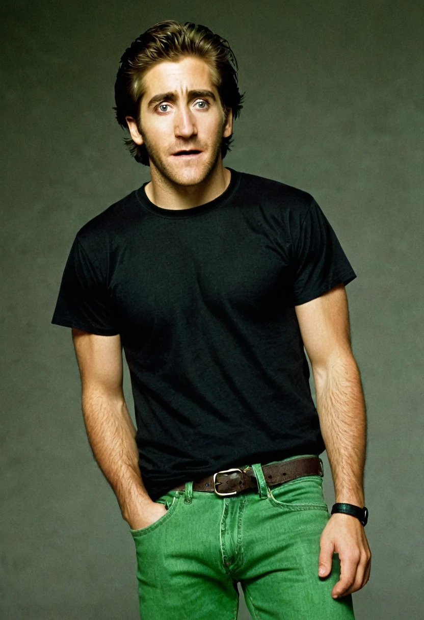 A young Jack Gyllenhaal, frightened expression, no beard, black T-shirt, green jeans, in full