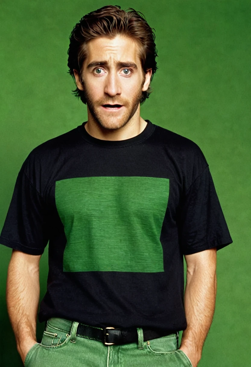 A young Jack Gyllenhaal, frightened expression, no beard, black T-shirt, green jeans, in full