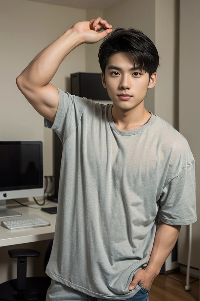 A young Asian man stands, handsome, muscular, looking at the camera. In a plain brown t-shirt, In the computer room